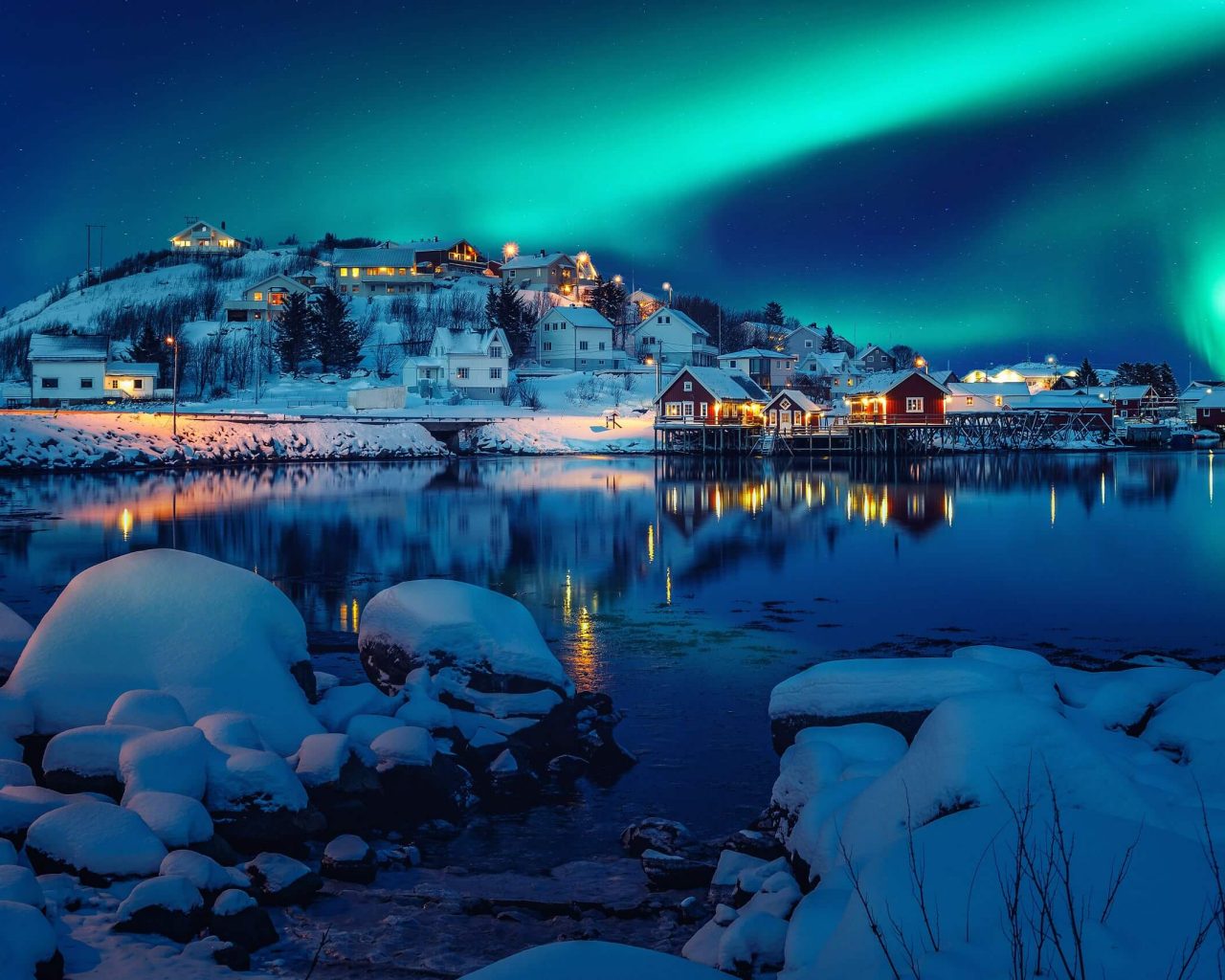 Foto escénica del pueblo pesquero de invierno con luces del norte